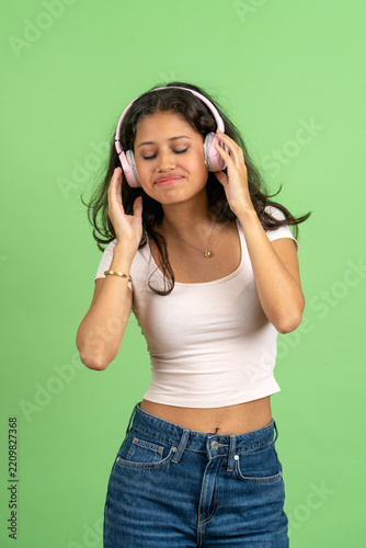 Young latina woman enjoying music with headphones