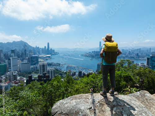 Woman hiking on mountain top in Hong Kong