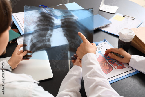 Medical diagnosis and clinical consultation, doctors analyzing lung x-ray sca...