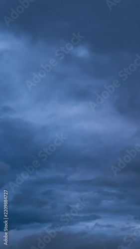 Dramatic time lapse of dark storm clouds rolling in, concept of bad weather and heavy rain.