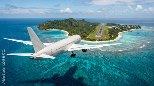 Commercial Airplane Flying very low Over Tropical Ocean Toward Island