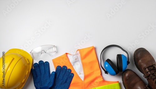 Construction safety equipment and personal protective gear on white