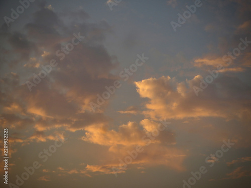 Spectacular Golden Hour Sunlight Illuminating Dramatic Clouds Across a Moody Evening Sky with Warm Amber Glow and Soft Twilight Atmosphere on West Lake in Hanoi, Vietnam