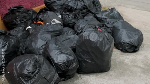 Large pile of black garbage bags illustrating household waste, excessive consumption, waste disposal, plastic pollution and the growing environmental impact of human activity.