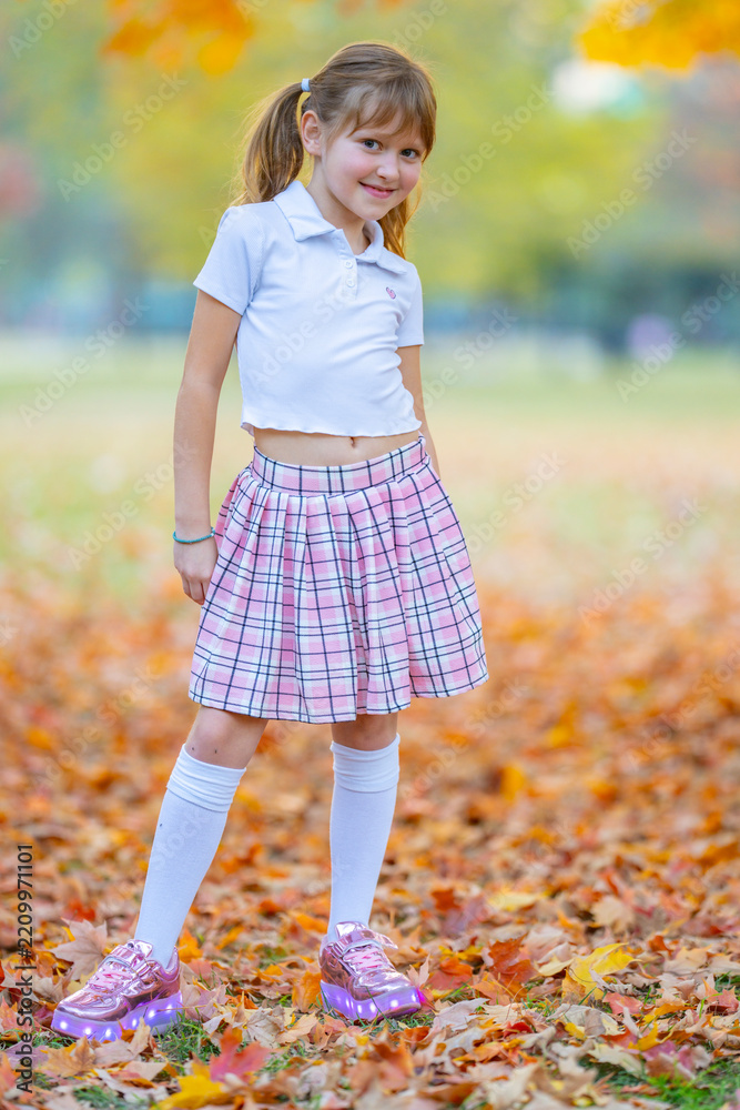 Obraz premium Skirt with casual jacket. Skirt on little girl. Stylish skirt in outdoor portrait. Cute skirt with autumn leaves.