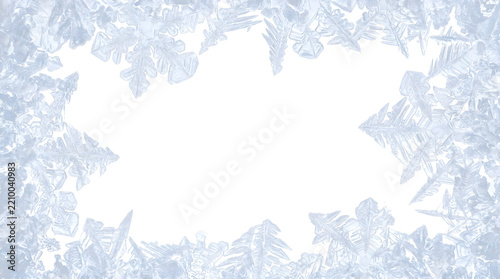 Fotografie Frame of icy blue frost crystals forming a delicate winter border around an empt