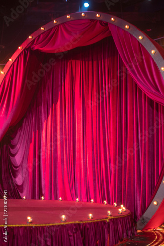 Red velvet theater curtain on retro stage with lights and copy space