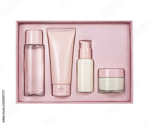 Beautiful pink cosmetic gift set with various skincare products, including a lotion, cream, and serum, elegantly arranged in a box against a clean white background