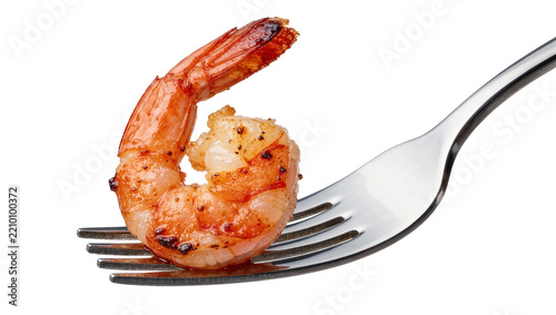 Cooked pink shrimp impaled on a silver fork, isolated on transparent background
