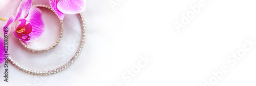 Bracelet and necklace on white fabric and purple Orchid
