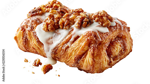Golden flaky cinnamon danish pastry topped with white icing and toasted walnuts