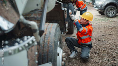 Asian Male Technician Inspecting Heavy Truck Chassis Safety Check