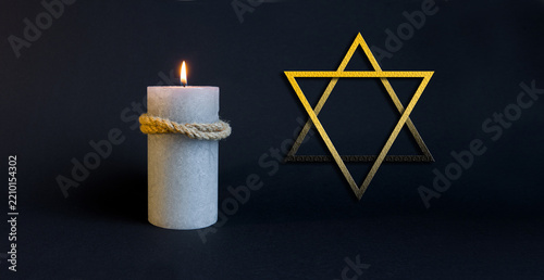 Fotografie Star of David and Memorial Candle on Dark Background
