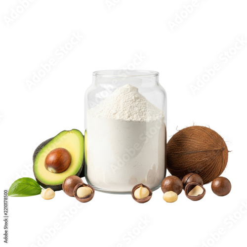 A glass jar filled with white powder surrounded by fresh avocado, macadamia nuts, and a coconut on a clean white background