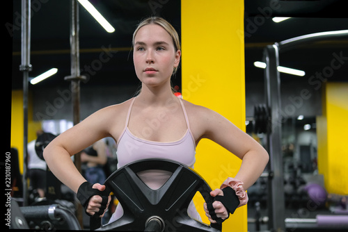 Woman weightlifting in gym focusing on strength and functional fitness