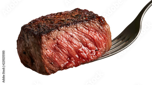 Medium rare grilled beef steak cube on a silver metal fork