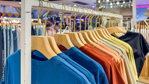 Row of colorful T- shirts hanging on