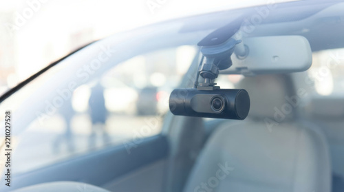 Dashboard camera recording city traffic through car windshield