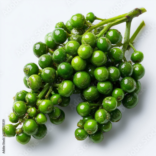 green peppercorn clusters on white background