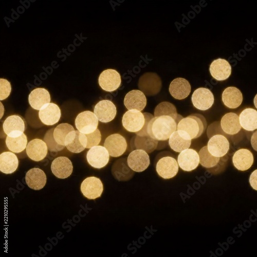 Golden bokeh lights on a black background creating a festive and elegant abstract pattern