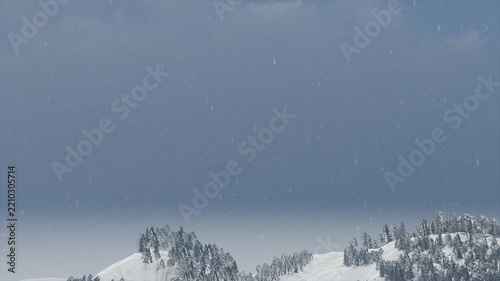 Snowfall over snow-covered mountains and trees, winter landscape