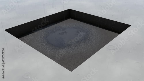 Rain falling into a square hole with a puddle forming, atmospheric