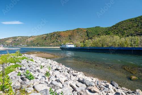 Dry riverbed of rhine river, extreme drought in Europe, impact freight transport and hinder shipping, low water level, upper middle valley near Kaub, Germany