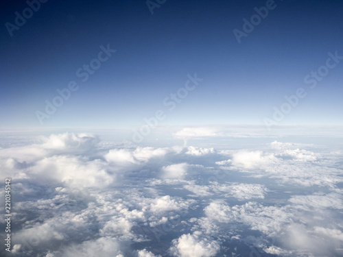 Above the clouds: vast cloudscape seen from an airplane window