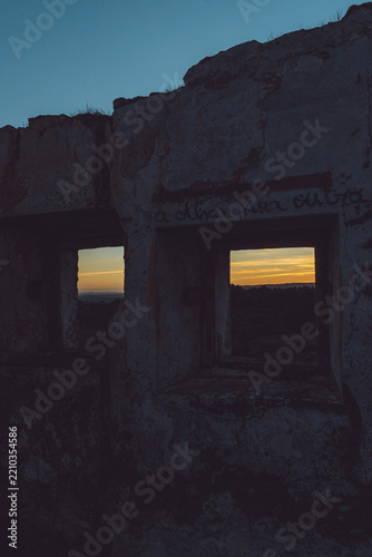 Scenic Sunset Framed by Ancient Stone Ruins in Évora, Portugal