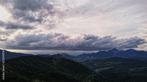 Aerial Hyperlapse Of Fast Moving Clouds Over Mountain Range At Dusk
