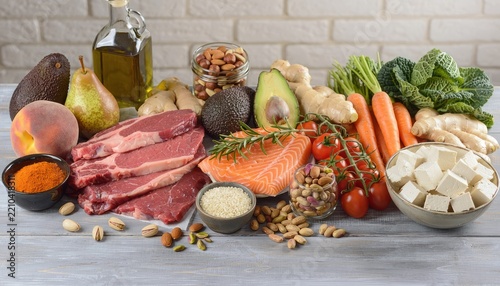 Healthy food assortment including meat, salmon, and vegetables.