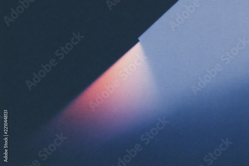 A piece of paper with a light shining through it creating a shadow on the wall. the paper appears to be a of a wall with the light emanating from it creating a soft ethereal glow.