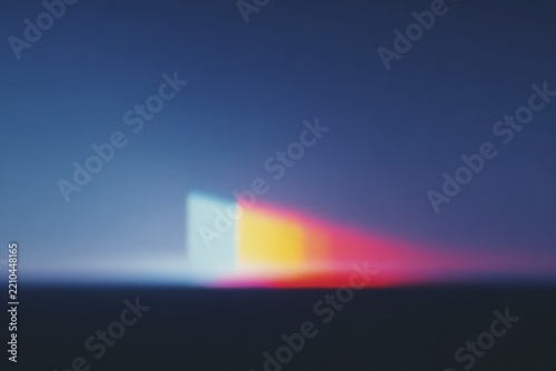 A blurry of a light beam in the middle of a dark blue sky with a red yellow and blue light emanating from it.