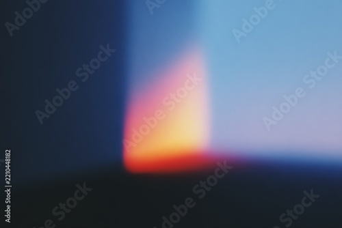 A blurry of a fire in the middle of a dark room with a red yellow and blue flame in the center. the background is slightly blurred giving the a dreamy feel.