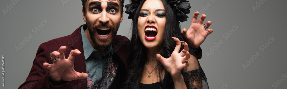 Obraz premium Couple celebrating Halloween joy in diverse costumes at a lively party, banner 