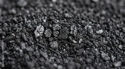 Macro photography of black graphite powder texture. Carbon mineral particles background
