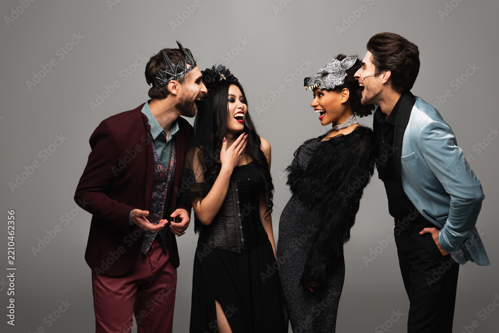 Obraz premium Group of cheerful multicultural friends celebrating Halloween with fun costumes