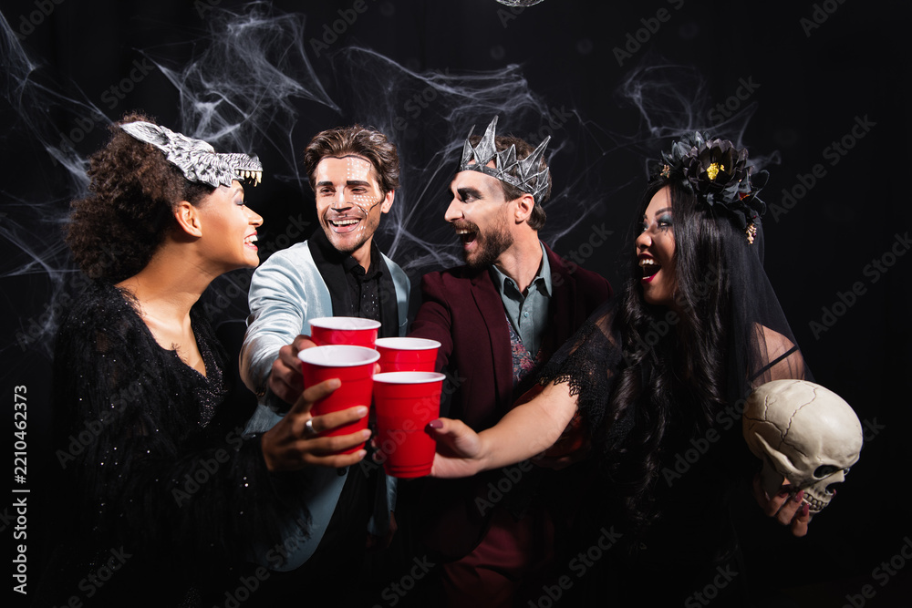Obraz premium Multicultural friends celebrating Halloween with costumes and joyful spirits