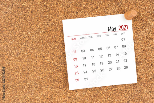 White calendar sheet for May 2027 with thumbtack on board, Position with copy space.