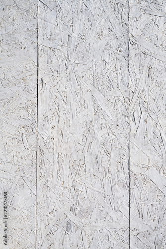 hite painted OSB panels with visible wood strand texture and vertical seams