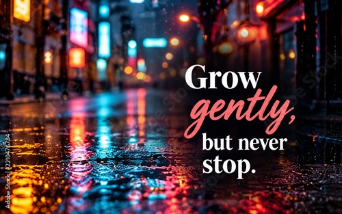 Rainy city street with colorful reflections and inspirational quote about growing gently while continuing forward.