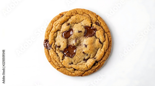 Freshly baked chocolate chip cookie on white surface.