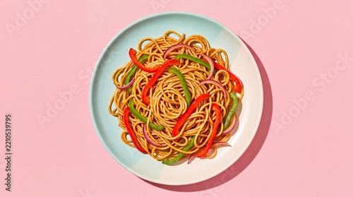 Stir fried noodles tossed with colorful bell peppers and sliced onions on a round ceramic plate