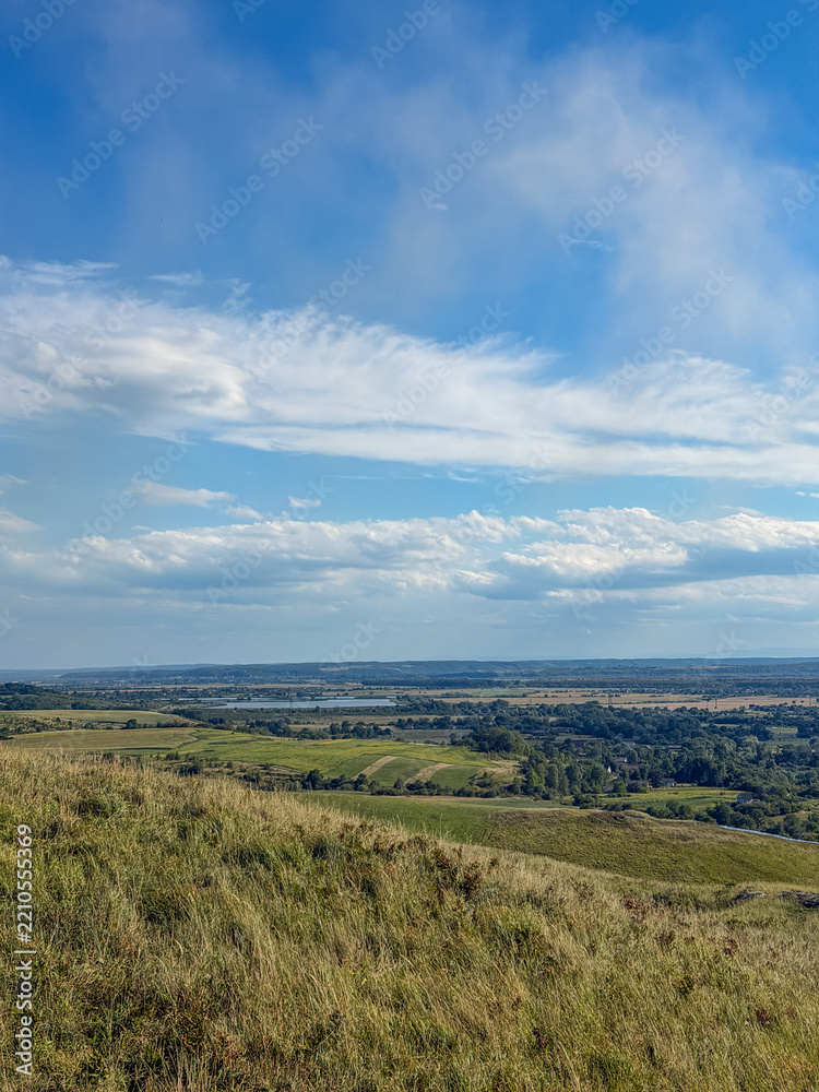 Fototapeta premium Rolling Green Hills and Dramatic Blue Sky in Ukrainian Countryside