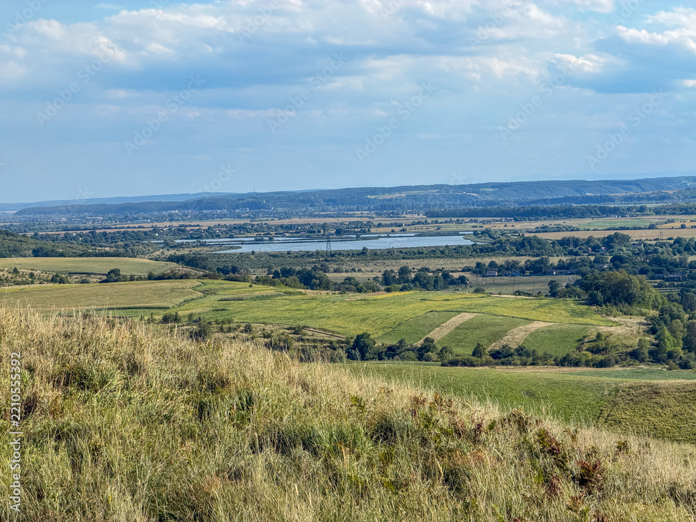 Obraz premium Rolling Green Hills and Dramatic Blue Sky in Ukrainian Countryside