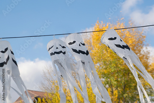 Spooky scary ghosts monster faces lanterns waving on wind on halloween background,autumn holidays,decoration and party concept