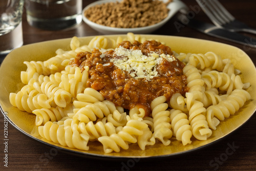 Fusilli pasta with plant-based bolognese sauce made from textured soy protein