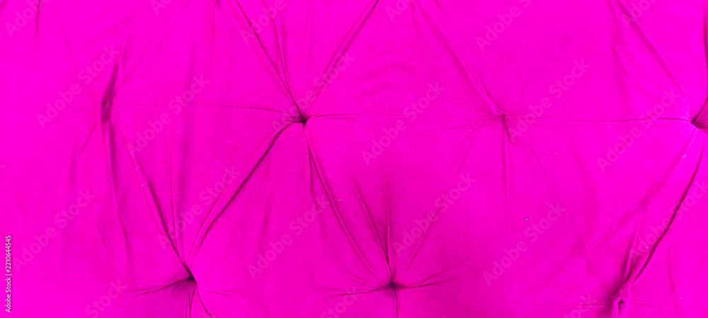 Fototapeta premium Hot pink velvet tufted upholstery texture background with quilted fabric buttons and elegant folds