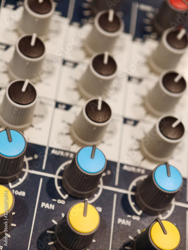 Audio mixing console with colorful control knobs