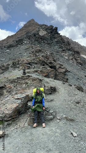 Hiking in Tian Shan Mountains Kyrgyzstan with a backpack at high altitude